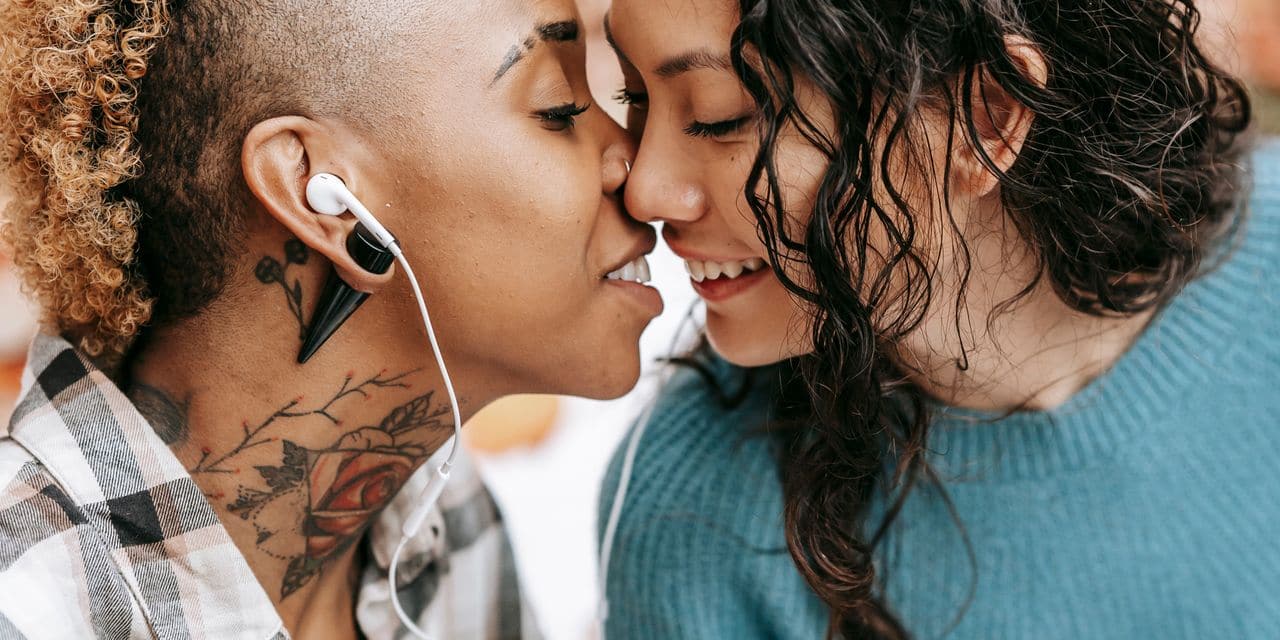 A close-up portrait capturing a tender moment between two women in love.